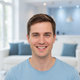 Portrait of a smiling German man in a light blue t-shirt, exuding trust and happiness.